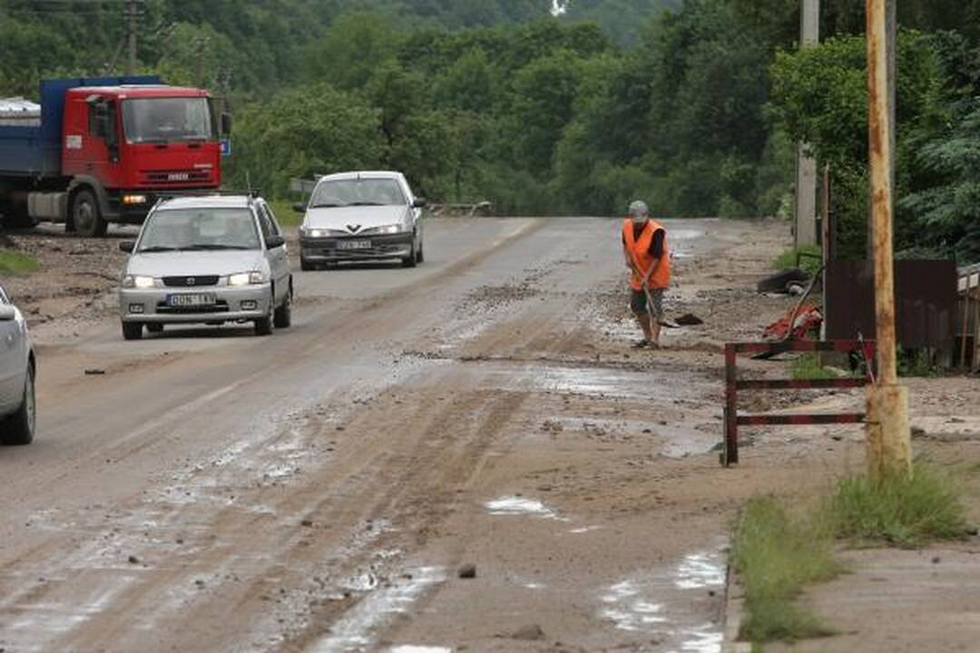 Lietus išardė asfaltą nuovažoje nuo tilto per Nerį